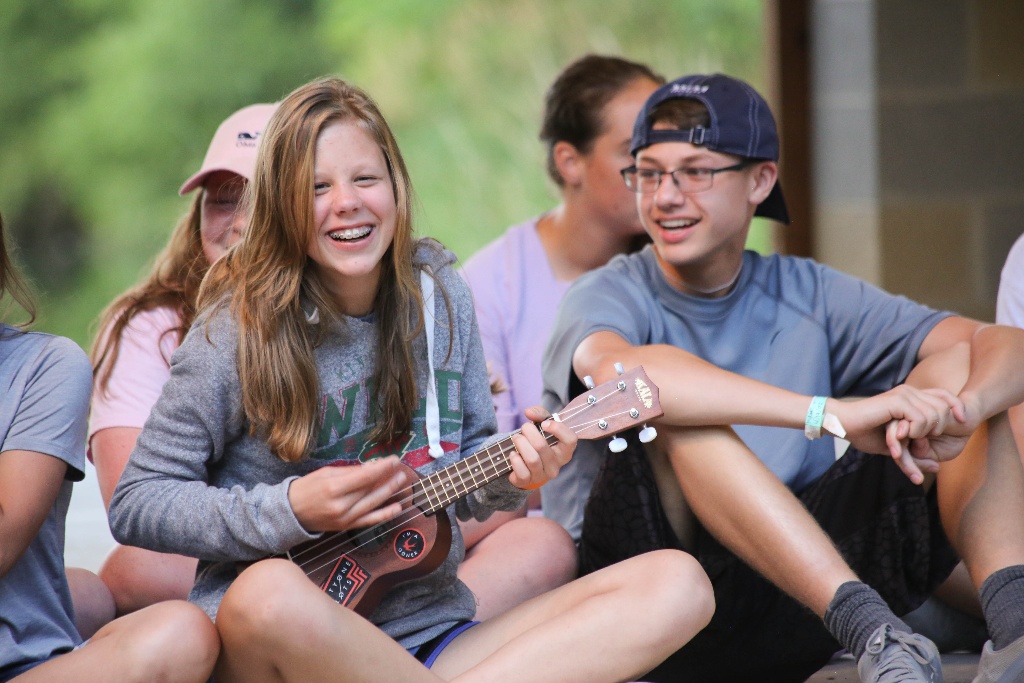 Camper strumming a ukelele during a Stage Night performance