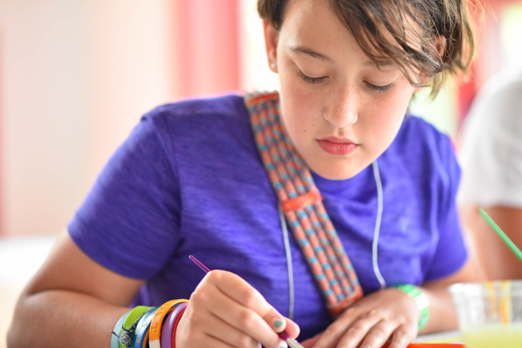 Camper decorating a journal